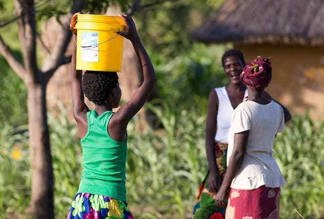 Water: Carrying the Burden - Child Carrying Water Bucket