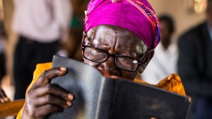 Gladys reads the Bible with her new glasses