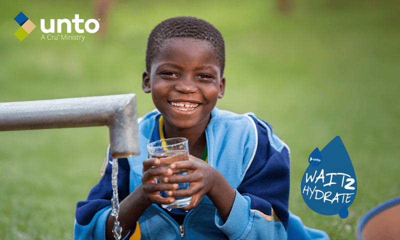 boy holds cup of water